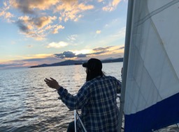 Juris meditates n a sunset sail